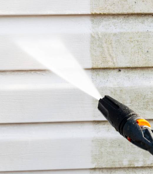 Cleaning service washing building facade with pressure water. Cleaning dirty waill with high pressure water jet. Power washing the wall. Ceaning the facade of the house. Before and after washing